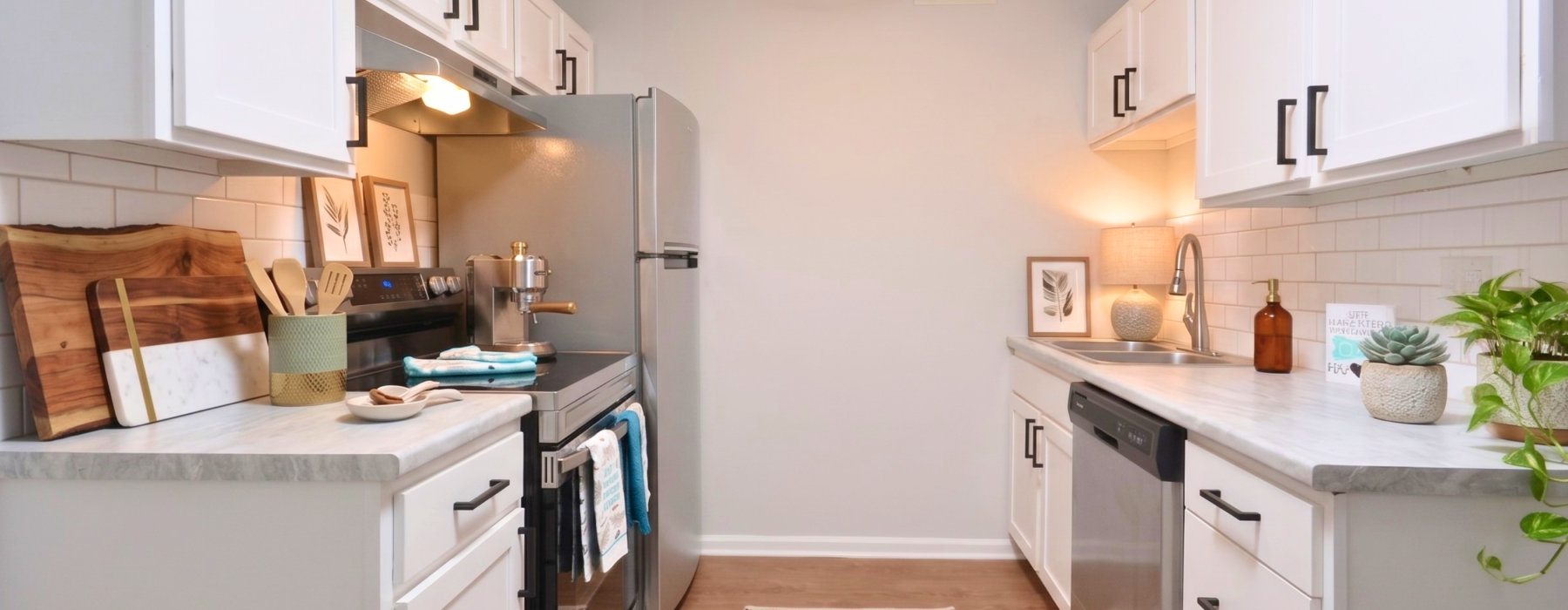 spacious and well lit kitchen with granite counter tops and stainless steel appliances 