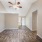 Room with wood floors can see the kitchen in the back of the room
