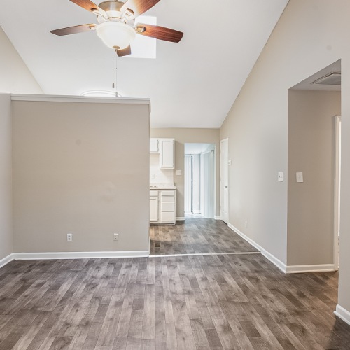 Living Room Room with wood floors can see the kitchen in the back of the room