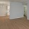 Spacious and well lit living room with wood floors and an open floor plan with access to the kitchen.